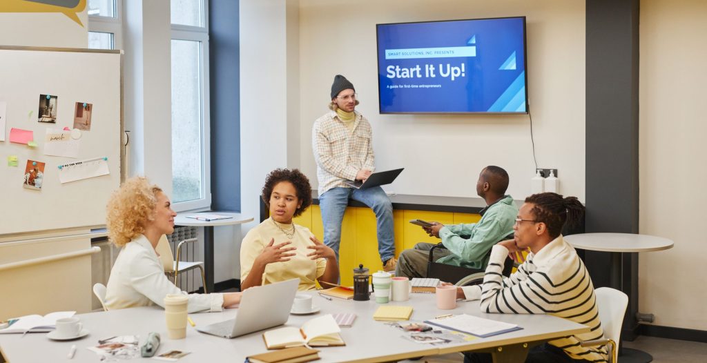 Diverse group discussing startup ideas in a creative office environment.